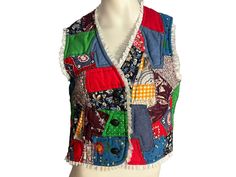 "Vintage handmade patchwork quilted vest, trimmed in lace, buttons up the front, is in great condition, measurements are bust up to 34\" waist up to 28\" length 18.5\"" Fitted Multicolor Patchwork Vest, Multicolor Patchwork Fitted Vest, Multicolor Patchwork Sleeveless Vest, Retro Cotton Patchwork Vest, Cotton Patchwork Sleeveless Vest, Sleeveless Cotton Patchwork Vest, Handmade Vest, Black Garter, Patchwork Vest