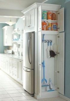 a kitchen with blue walls, white cabinets and tile flooring is seen in this image