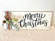 a wooden sign that says merry christmas on it