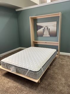 the mattress is in an empty room with no sheets on it