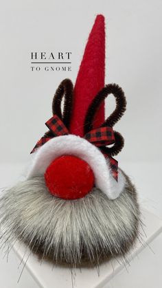 a red and white santa claus hat on top of a fake moustacher