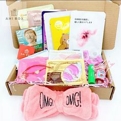 an open box with pink gloves and other items in it that say omg on the inside