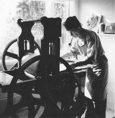 a woman working on an old spinning wheel