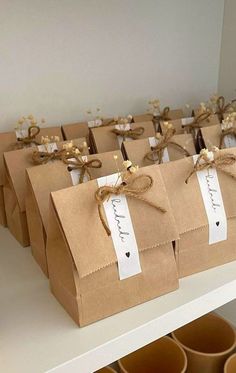 brown paper bags with tags tied to them are sitting on a shelf in a store