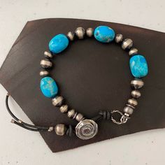 This is a lovey petite Kingman turquoise bracelet with four nuggets averaging 12-14 mm in size.  The are separated by sterling silver Navajo pearls and attach with a handmade sterling silver button.  This is a beautiful one of a kind piece that will look great with other silver pieces.  This bracelet fits a 6.5 inch wrist. Adjustable Southwestern Jewelry With Silver Beads, Adjustable Southwestern Style Bracelet With Silver Beads, Southwestern Style Adjustable Silver Beads Bracelet, Adjustable Southwestern Silver Beaded Bracelets, Adjustable Southwestern Silver Beaded Jewelry, Adjustable Southwestern Style Silver Beaded Bracelets, Southwestern Style Adjustable Silver Beaded Bracelet, Adjustable Silver Beaded Bracelets In Southwestern Style, Adjustable Silver Beaded Southwestern Bracelet