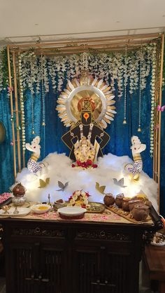 an idol sitting on top of a table surrounded by other decorations and decorating items