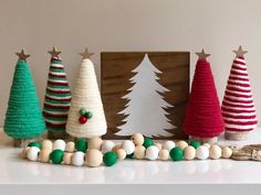 christmas trees are lined up on the mantle