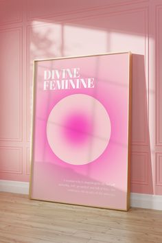 a pink poster with the words divine feminine on it in front of a pink wall