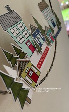 the paper houses are hanging on the wall