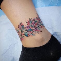 a woman's foot with a flower tattoo on it