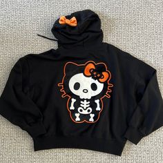 New With Tag. Hello Kitty Black Skeleton Hoodie. Size S Hello Kitty Print Long Sleeve Hoodie For Streetwear, Black Cartoon Print Hoodie Top, Cute Fall Streetwear Tops, Black Hooded Top With Cartoon Print, Cute Fall Sweatshirt For Streetwear, Cute Sweatshirt For Fall Streetwear, Cute Fall Streetwear Sweatshirt, Cute Streetwear Sweatshirt For Fall, Black Skull Print Hoodie