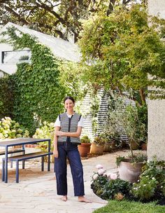 a woman standing in the middle of a garden