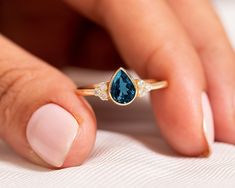 "Pear Cut London Blue Topaz Engagement Ring,14k Solid Gold Cluster Diamond Ring,Solitaire Proposal Ring,Delicate Jewelry,Elegant Promise Ring ★ ★ ★ ★  CUSTOM/DUTY-FREE SHIPPING WORLDWIDE, BUYERS DON'T HAVE TO PAY ANY CUSTOM FEES WHILE IMPORTING ★ ★ ★ ★  Details Made to order Material: 14k/18k Gold Color Options: Yellow Gold, White Gold, Rose Gold,  ★ Center Stone:  London Blue Topaz, Pear Size: 5 x 7 mm Approx Weight (Ct): 0.69 ★ Accent Stones:  Diamond/Moissanite, Round Size: 1.5 mm * 6 No.s Approx Weight (Ct): 0.084 ★ 100% Natural Diamond and Gemstones ★ Diamond: Round Brilliant cut, G-H Color, SI Clarity ☂ Shipped with Insured Shipping within 4-7 business days. ➦ 100% Free Returns. ➦ Our Jewelry comes with a Lifetime Warranty. (Stone Replacement not included) ✈ We offer free EXPRESS shi Luxury Promise Ring With Round Cut Topaz, Luxury Topaz Promise Ring With Prong Setting, Luxury Topaz Promise Ring With Round Cut, Luxury Solitaire Topaz Promise Ring, Luxury Minimalist Topaz Ring, Luxury Topaz Promise Ring With Accent Stones, Luxury Topaz Promise Ring With Diamond Accents, Luxury Rose Cut Diamond Topaz Promise Ring, Luxury Polished Finish Topaz Promise Ring