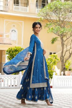 This Blue Rayon Leheriya Embroidered Sharara Suit features a long kurta with Zari and Sequins embroidery accents on the yoke, sleeves, and hemline. The suit includes a coordinating sharara and a printed chiffon dupatta with an embroidered border for a unique, elegant look. Perfect for special occasions. Color: Blue Top: Rayon Bottom: Rayon Dupatta: Chiffon Top Length: 46" Bottom Length: 41" Dupatta Size: 2.2 m Occasion: Festive Print-Pattern: Leheriya Ornamentation: Zari Shape: Straight Design S Leheriya Suit Design, Leheriya Dress, Phulkari Pants, Lucknowi Kurta, Gharara Suits, Patiala Salwar Suits, Embroidered Sharara, Bridal Dupatta, Anarkali Dress Pattern