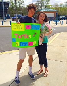 a man and woman holding up a sign that says, smile you truly to prom