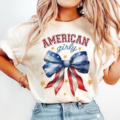 "Comfort Colors Shirt, Coquette American Girly Shirt, Coquette Bow Shirt, 4th of July Shirt, America Shirt, Freedom Shirt,American Flag Shirt Greetings! *ABOUT OUR T-SHIRT QUALITY Skillfully printed with our state-of-the-art printing machine. Key Features of Comfort Colors 1717 Unisex Heavyweight Tee 6.1 oz./yd² (US), 10 oz/L yd (CA), 100% ring-spun cotton, 20 singles Soft ring-spun fabric dyed for a unique look Relaxed fit for ultimate comfort Topstitched, classic width, rib collar Twill taped Cute Cotton T-shirt For 4th Of July, Cute American Flag Print T-shirt For Summer, Cute Short Sleeve Shirt For 4th Of July, Labor Day Americana Style Cotton Tops, Labor Day Americana Cotton Tops, Cute Short Sleeve Tops For Independence Day, Cute Cotton Independence Day Top, Cute Cotton Top For Independence Day, Trendy Cotton Tops For Independence Day