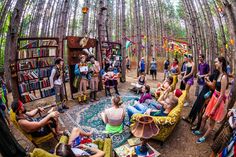 a group of people sitting around in the woods