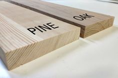 two pieces of wood with the words pine and oak written on one side, sitting next to each other