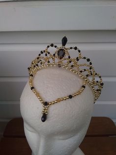 Handmade crystal ballet headpiece in your choice of strong colour with silver or gold (pictured is black and gold). Suitable for Odile (Black Swan), Satanella, or Carabosse. Made with crystal beads, acrylic pearls, crystal bead droplets, and a crystal teardrop jewel. Base of crown measures approx. 31cm. Centre front height measures approx. 5.5cm. Base of frontpiece measures approx. 21cm. Shipping Information: - Shipping to the United States and Canada takes approx. 12 to 28 working days. - Shipp Black Swan Lake Dress, Black Swan Accessories, Odile Black Swan, Black Swan Headpiece, Black Swan Tiara, White Swan Headpiece, Swan Lake Headpiece, Swan Lake Costumes, Arabian Ballet Headpiece