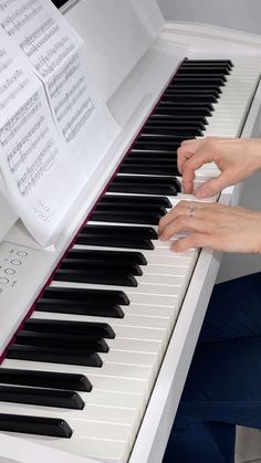 a woman is playing the piano with her hands