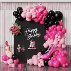 a pink and black birthday party with balloons, streamers and cake on the table