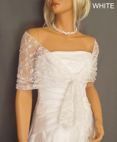 a mannequin wearing a white wedding dress