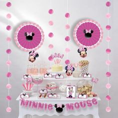 a minnie mouse dessert table with pink decorations