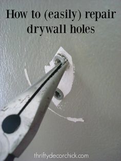 a close up of a pair of scissors with the words how to easily repair drywall holes