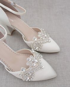 Almond toe satin block heel embellished with rhinestones applique gives just a hint of shimmer for the most stylish and elegant bride. Depending on satin color, embellishments come in silver, gold, or black rhinestones. Perfect for weddings, bridal party shoes, bridesmaids, and all special occasions. DETAILS:HEEL HEIGHT: 2.75 inchesUPPER: Synthetic upper and liningMATERIALS: Manmade outsoleSTYLE NAME: SALLY Block Heels Bridal, Bridal Party Shoes Bridesmaids, Bridal Party Shoes, Ivory Bridal Shoes, Wedding Shoes Comfortable, Bridal Flats, Elegant Heels, Satin Shoes, Bridal Sandals