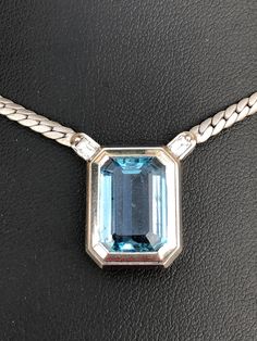 A lovely, stylishly simple rectangular step cut aquamarine, with two baguette diamonds on the mounting, which set off this piece of jewellery to perfection. The aquamarine is a good mid blue colour and very clear.  Length of pendant 1.5 cm x  1.2 cm, whole length ( chain and pendant) 23cm. Weight 22.6gram. P84 Rectangular Blue Diamond Jewelry, Blue Rectangular Diamond Jewelry, Classic Light Blue Emerald Cut Jewelry, Blue Emerald-cut Baguette Diamond Jewelry, Modern Blue Emerald-cut Jewelry, Modern Light Blue Jewelry For Formal Occasions, Classic Aquamarine Rectangular Jewelry, Classic Rectangular Aquamarine Jewelry, Chain And Pendant