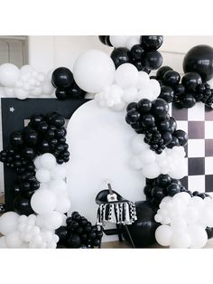 black and white balloon arch with checkerboard backdrop