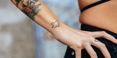 a woman's arm with a tattoo on it and a star in the middle