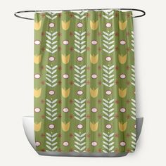 a green shower curtain with yellow and white flowers on the outside, in front of a gray background