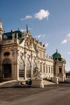 a large building with statues in front of it