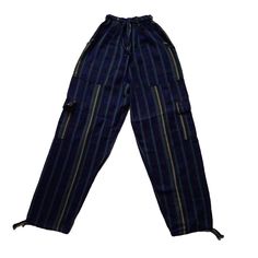 Nice comfy pants for going to the beach, camping, or spending the day at home.These hippie pants have 2 pockets on the front + 2 cargo pockets +1 pocket on the back.They are high-waisted boho pants. They have a drawstring in the waist. It was handmade by Ecuadorian artisans using the foot-treadle loom technique.Materials:75% cotton and 25% acrylic Measurements:Waist circumference: stretches from 24" up to 34"Hip circumference: 42"Rise: 11"Inseam: 28"Total Length: 39"Thigh: 12"Leg opening: 8" Car Indigo Bohemian Relaxed Fit Bottoms, Blue Relaxed Fit Harem Pants With Pockets, Wide-leg Cargo Pants With Pockets For Festivals, Wide Leg Cargo Pants With Pockets For Festival, Wide Leg Cargo Pants For Festivals, Cotton Cargo Pants With Pockets For Beach, Baggy Casual Cargo Pants For Festivals, Beach Cotton Cargo Pants With Pockets, Baggy Blue Pants For The Beach