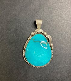 Navajo Jewelry Handcrafted Sterling Silver and Turquoise Pendant by S Cooke This stunning handcrafted turquoise and sterling silver pendant was created by Navajo artist S. Cooke.  No filters, or enhancements, were used during or after photograph.  This particular pendant just happens to be photogenic.  - Gemstone : Turquoise - Metal : 925 Sterling Silver - S Cooke Stamped - Sterling Stamped    - Pendant Length : 2" including bail | Width: 1.25" *Measurements are approximate. **Please note: this listing is for the pendant only. Turquoise and Navajo Pearl necklace sold separately. Southwestern Engraved Turquoise Necklace, Southwestern Turquoise Necklace With Large Stone, Engraved Southwestern Turquoise Necklace, Southwestern Untreated Turquoise Necklace, Untreated Southwestern Turquoise Necklace, Southwestern Untreated Turquoise Collectible Necklace, Collectible Southwestern Turquoise Pendant Necklace, Southwestern Turquoise Pendant Necklace, Southwestern Style Turquoise Pendant Necklace