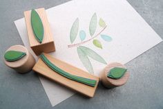 a wooden stamp with leaves on it