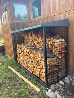 a large pile of logs sitting in front of a building