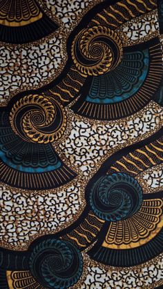 an intricately designed fabric with gold and blue designs on the front, black and white background