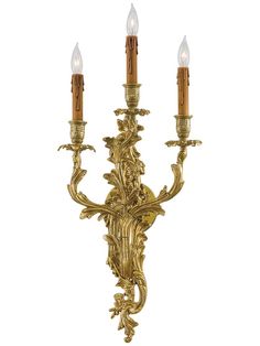 an ornate wall light with three candles on it