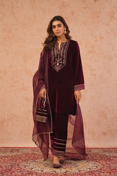 PRODUCT DETAIL:  Elevate your style with the Regal Wine Velvet Suit, a perfect blend of opulence and sophistication. This exquisite ensemble features a bold embroidered neckline that exudes regal charm. The intricate embroidery on the sleeves and pants adds a touch of luxury, making it a standout choice for special occ Wine Velvet Suit, Punjabi Suit Boutique, Velvet Dupatta, Designer Punjabi Suits