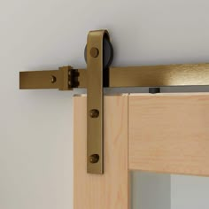 a close up of a wooden door hinge with a metal handle on the side