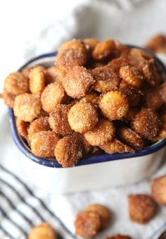 a bowl filled with sugared nuts on top of a table