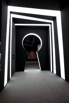 a black and white room with an oval mirror on the wall next to it's doorway