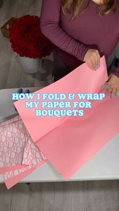 a woman is cutting out some pink paper for her bouquets, with the words how i fold and wrap my paper for bouquets written on it