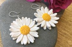 "Handmade large daisy dangle earrings earrings.  Extremely lightweight, made from polymer clay, with a choice of gold tone, silver tone or sterling silver ear hooks. Each daisy measures 4cm/1 5/8\" in length, plus ear wire, roughly 4cm/  1 5/8'' wide (see photos in my hand for size). Great summer accessory, lovely gift. Also available as a yellow sunflower. UK made earrings." Handmade White Flower Earrings For Everyday, White Daisy Jewelry For Everyday, Cute White Jewelry With 3d Flowers, Handmade White Sterling Silver Flower Earrings, Everyday White Flower Earrings In Polymer Clay, White Polymer Clay Flower Earrings For Everyday Wear, Handmade Daisy Earrings As Gift, Everyday White Daisy Shaped Jewelry, Everyday White Polymer Clay Flower Earrings