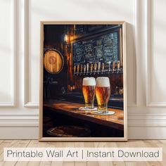 two beer glasses sitting on top of a wooden table next to a wall mounted poster