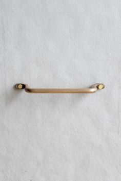 a gold colored handle on a white towel