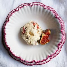 a white plate topped with an ice cream and sliced figaroni on top of it