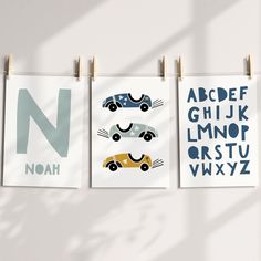 three children's posters hanging on clothes pins with letters and numbers written in them